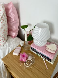 a wooden table topped with pink and white items