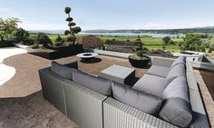 an outdoor living area with couches, tables and plants on the roof overlooking a lake