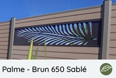 the palm tree is on display in front of a wooden fence with text that reads, palm - brun 650 sabie