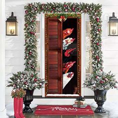 an open door decorated with flowers and greenery