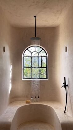 a bath room with a large tub and a window in it's side wall