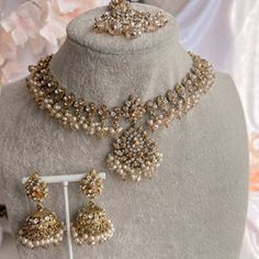 a necklace and earring set on display