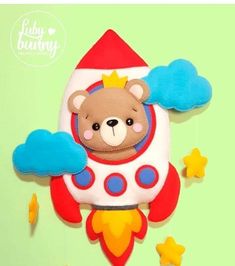 a teddy bear in a rocket with stars around it