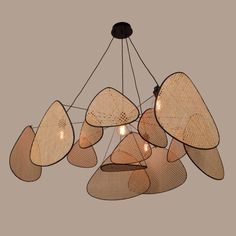 a chandelier made out of woven material with lights hanging from the top and bottom