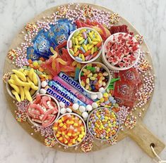 a wooden platter filled with candy and candies