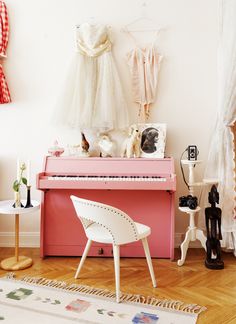 there is a pink piano in the room