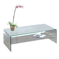 a glass coffee table with a flower on top