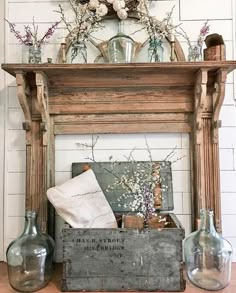 an old wooden fireplace with vases and other items on the mantel above it