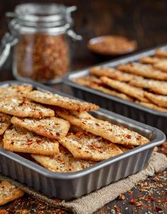 two pans filled with crackers sitting on top of a table