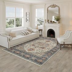 a living room filled with furniture and a fire place under a window on top of a hard wood floor