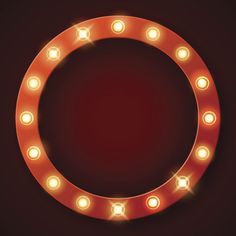 a round light up sign with many lights around it on a dark background, in the shape of a circle