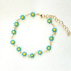 Dainty Blue Enamel Daisies With Yellow Center In A Gold Toned Bracelet. Bracelet Approx. 6.5” With A 2” Extension More Color Options Available. Multicolor Necklace Also Available. See My Other Listings For More Jewelry. Bundle And Save On Shipping. #B3 Blue Flower Bracelets For Beach, Bohemian Turquoise Bracelets For Spring, Bohemian Turquoise Bracelet For Spring, Light Blue Bohemian Bracelet For Summer, Spring Turquoise Bracelet Jewelry, Spring Turquoise Jewelry Bracelet, Trendy Blue Flower Bracelet, Trendy Blue Flower Shaped Jewelry, Adjustable Turquoise Bracelets For Spring