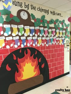 a bulletin board with a fire place and christmas decorations on the wall in an elementary classroom