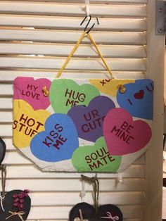 several heart shaped magnets hanging on a wall