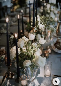 the table is set with candles and flowers