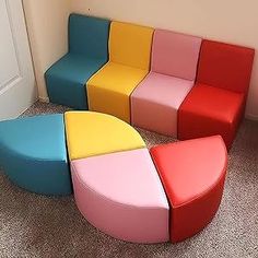 four different colored chairs sitting next to each other