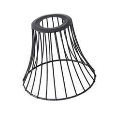 a black wire lamp shade sitting on top of a white wall