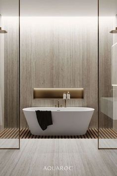 a white bath tub sitting inside of a bathroom next to a walk in glass shower