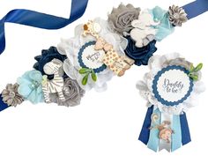 two ribbons are attached to each other with baby items on them, and the ribbon is blue