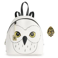 an owl backpack with a harry potter badge on the front, and a hogwarts pin in the back