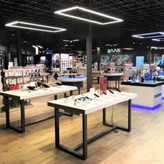 the inside of a store with several tables and phones on display in front of them