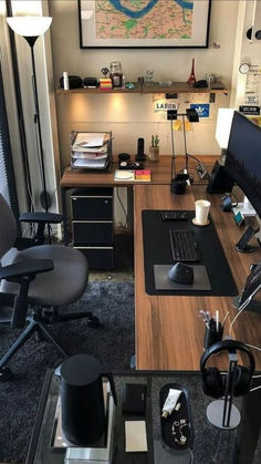 a desk with a computer, keyboard and mouse on it in front of a map