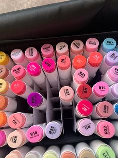 many different colored markers in a black case