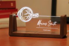 a glass plaque with a woman's profile on it sitting on a table next to books