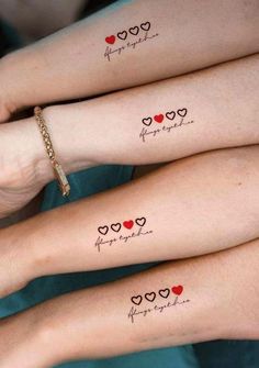 three girls with matching tattoos on their arms that say happy valentine's day and have hearts