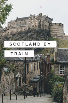 the words scotland by train are in front of an old castle with stairs leading up to it