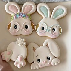 decorated cookies in the shape of rabbits with glasses