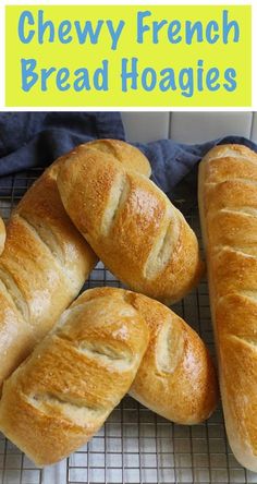 several loaves of bread sitting on top of a cooling rack with the words chewy french bread hoagies