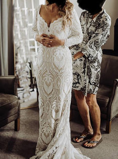 two women in wedding dresses standing next to each other