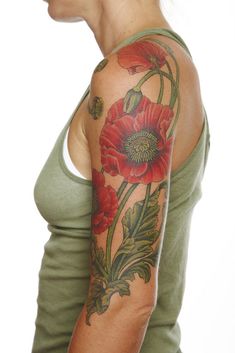 a woman with a flower tattoo on her arm and shoulder is looking at the camera