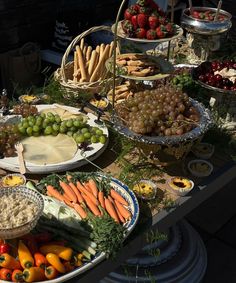 an assortment of fruits and vegetables are on display at a buffet table for people to eat