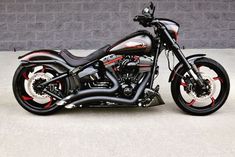 a black and red motorcycle parked in front of a building