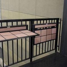 two metal railings with pink tiles on them