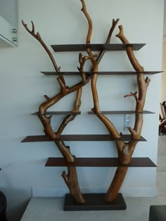 a wooden tree sculpture sitting on top of a shelf