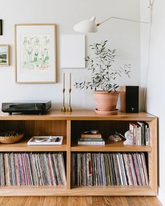 an entertainment center with record players and records