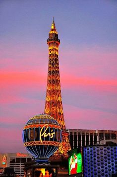 the eiffel tower is lit up at night