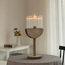 a lit candle holder on top of a table