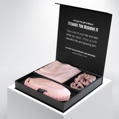 an open black box with pink clothing inside