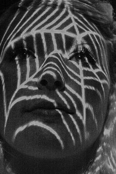 a woman's face with lines drawn on her body and the image of a zebra