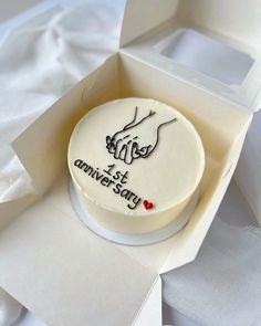 a white cake in a box with writing on it