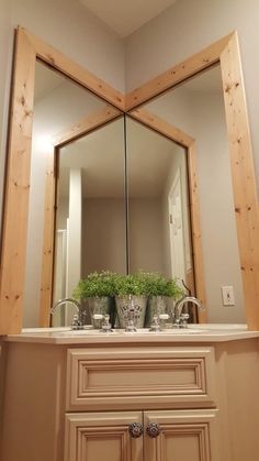 a bathroom vanity with two vases on it and a large mirror over the sink