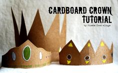 cardboard crowns with faces made to look like castle buildings and trees are shown in front of a white background