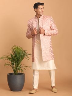 Vastramay Men's Pink Mirror Indo Western Sherwani with Kurta Pyjama Set Look impeccably stylish in this pink mirror work Sherwani set. Featuring a trendy Indo-Western design, the Sherwani boasts intricate mirror work and a mandarin collar, while the Kurta and Pyjama complement perfectly. Key Features Aqua blue mirror work design on Sherwani Mandarin collar, full sleeves on Sherwani, Kurta & Pyjama Cream colored Kurta and Pyjama Elasticated waistband with button closure on Pyjama Specifications S Pink Sherwani With Mirror Work For Designer Wear, Bollywood Style Pink Sherwani With Mirror Work, Pink Bollywood Sherwani With Mirror Work, Pink Bandhgala With Resham Embroidery For Eid, Pink Fitted Bollywood Sherwani, Pink Bandhgala With Zari Work For Eid, Traditional Pink Bandhgala For Designer Wear, Unstitched Pink Bollywood Bandhgala, Pink Traditional Bandhgala For Designer Wear