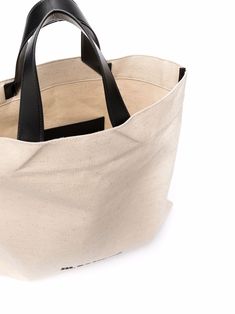 Light beige/black fabric/leather logo-print tote bag from JIL SANDER featuring logo print to the front, open top, two top handles, main compartment and internal slip pocket. | Jil Sander Logo-Print Tote Bag Leather Logo, Open Top, Jil Sander, Print Tote, Printed Tote Bags, Light Beige, Sanders, Black Fabric, Logo Print