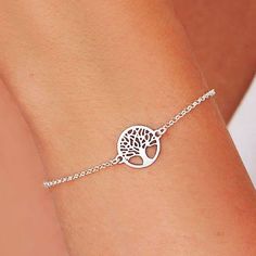 Bracelet made of 925 Sterling Silver decorated in its central part with a round medal with a silhouette of the Tree of Life. This bracelet is full of meaning and spirituality. It is an ideal gift for a friend, mother or daughter and transmits the force of eternal connection. The bracelet is 17 cm long and has another 3 cm of extension. It is made entirely of 925 Sterling Silver Sterling Silver Round Charm Bracelet, Symbolic Sterling Silver Round Bracelet For Gifts, Symbolic Sterling Silver Round Bracelet Gift, Symbolic Sterling Silver Round Bracelet, Nickel Free Circular Bracelets For Gift, Adjustable Silver Bracelet, Amulet Bracelet, Dagger Earrings, Tree Of Life Bracelet