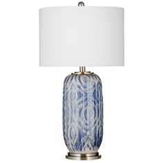 a blue and white table lamp with a white shade on the top, against a white background